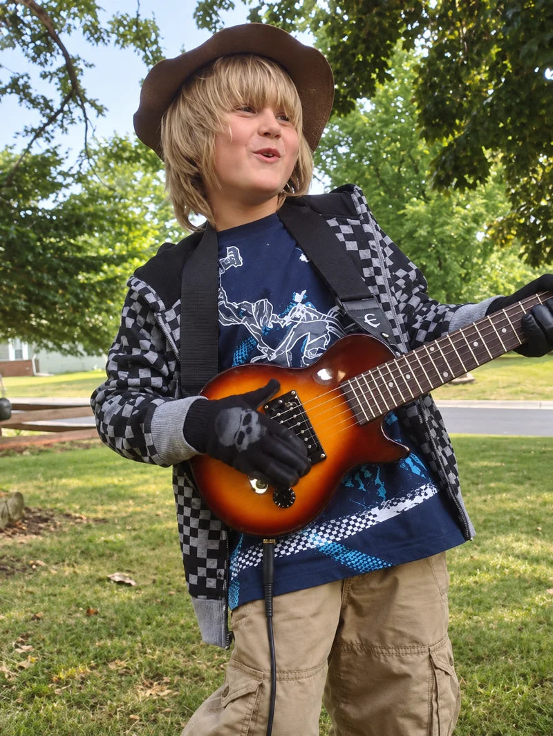 Dag as a child playing guitar outdoors